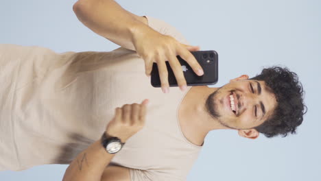 Vertical-video-of-Dancing-man-with-phone-in-hand.